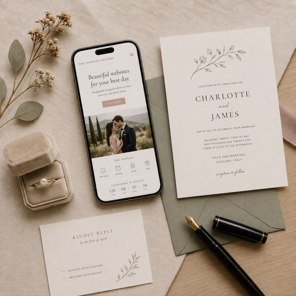 A phone displays a Wedding Keepers example site beside elegant invitation stationery, a fountain pen and a velvet ring box